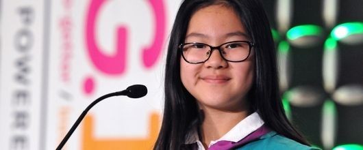 A Girl Scout standing in front of a microphone