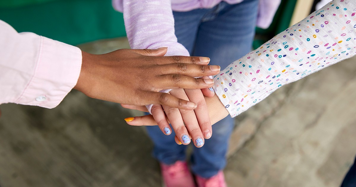 Girl and Volunteer Hands In