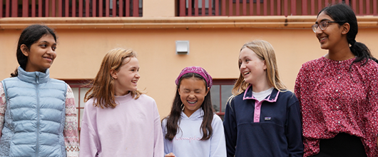 Group of five Girl Scouts talking outside