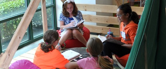 Four Girl Scouts Sit in a Tent at the Tampa Leadership Center